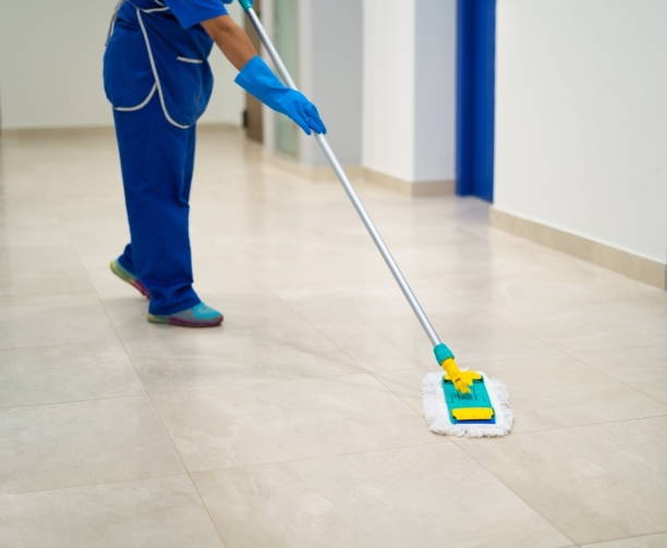 Female cleaner using a mop to clean a home, highlighting our professional cleaning services.