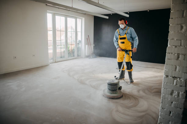 A man uses a specialized machine to polish the floor.