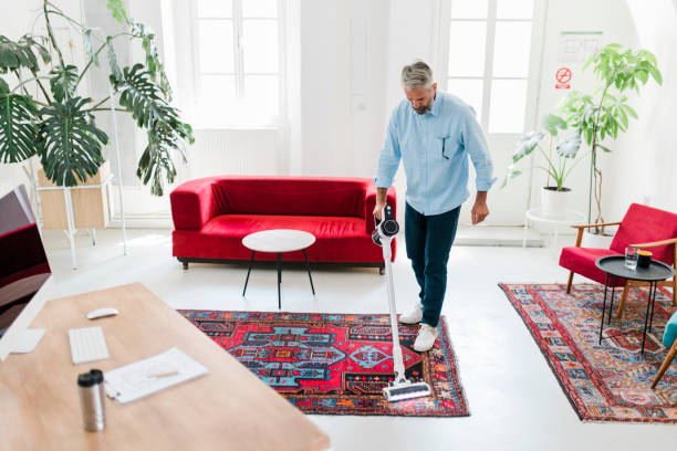 Man cleaning house with wireless vacuum cleaner