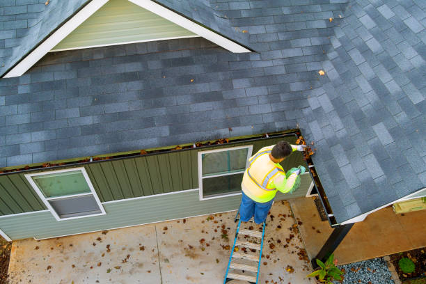 Worker carefully hand-cleaning wall tiles as part of our cleaning services.