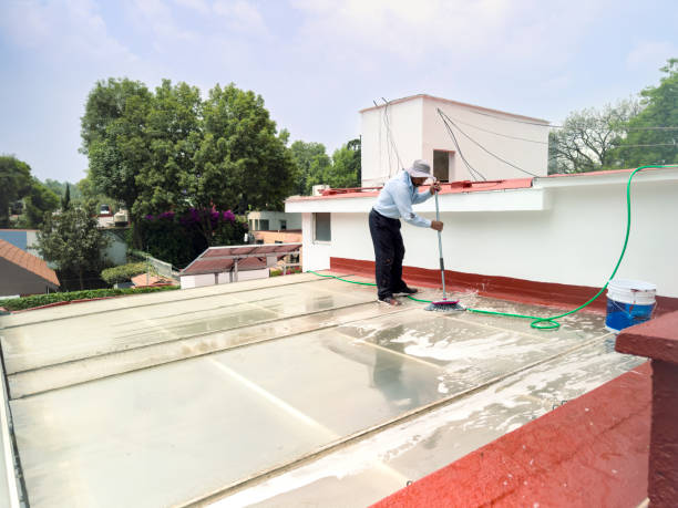 A Male cleaner is involved in cleaning and maintaining a polycarbonate roof.