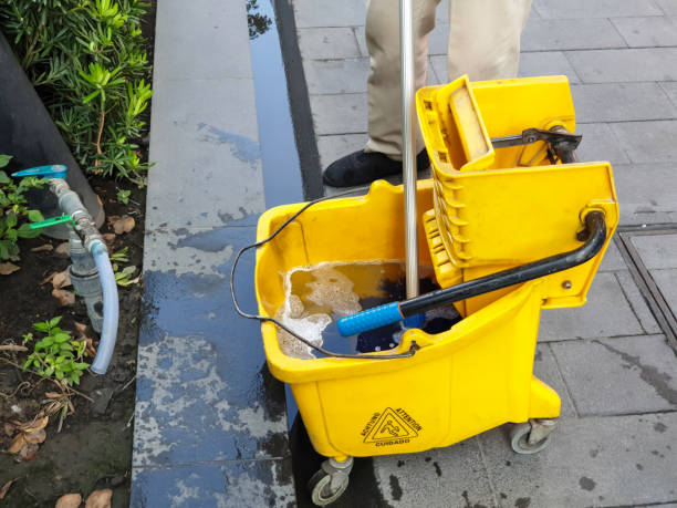 Yellow cleaning cart stocked with essential supplies for effective cleaning.