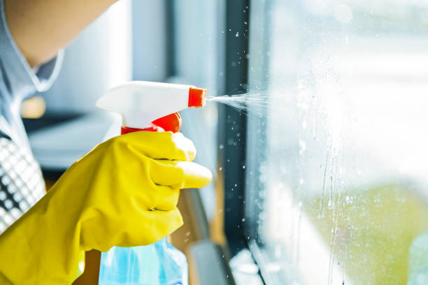 Young woman washing window