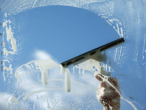 Cleaner delivers window cleaning with squeegee.