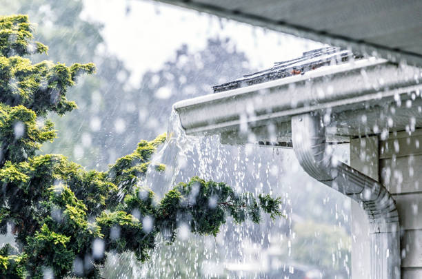 A flooded gutter system caused by heavy rainfall.