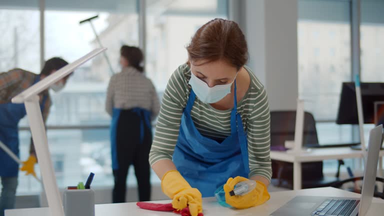 A female cleaner perform office cleaning Services.