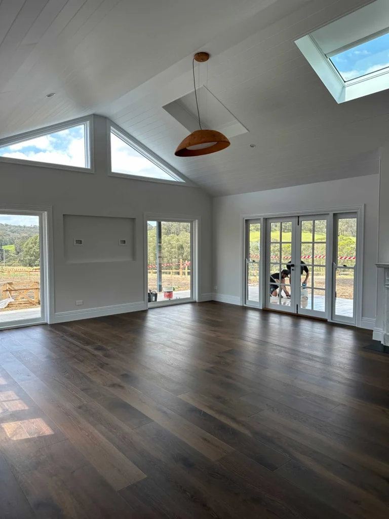 Cleaner organizing clutter in a bright, airy living space.