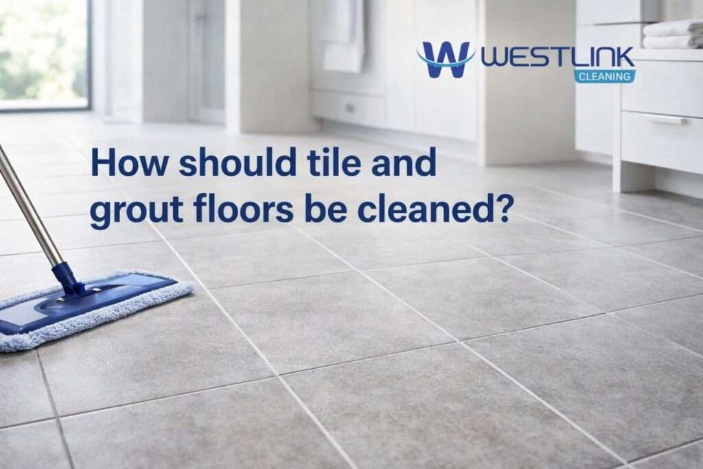 Realistic tile and grout floor being cleaned carefully in a premium modern interior with visible grout detail.