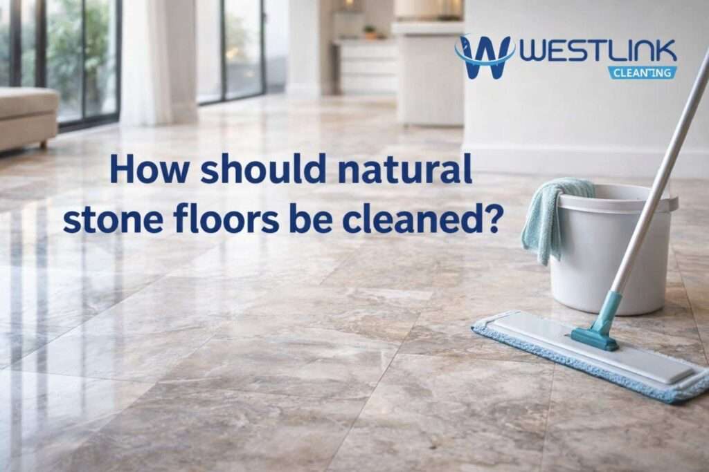 Realistic natural stone floor being cleaned carefully in a premium modern interior with visible stone texture and finish detail.