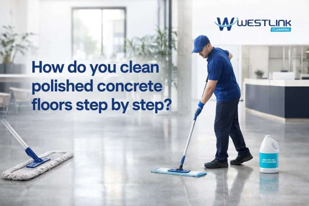 Professional cleaner dust mopping and damp mopping a polished concrete floor in a modern commercial interior using proper floor care tools