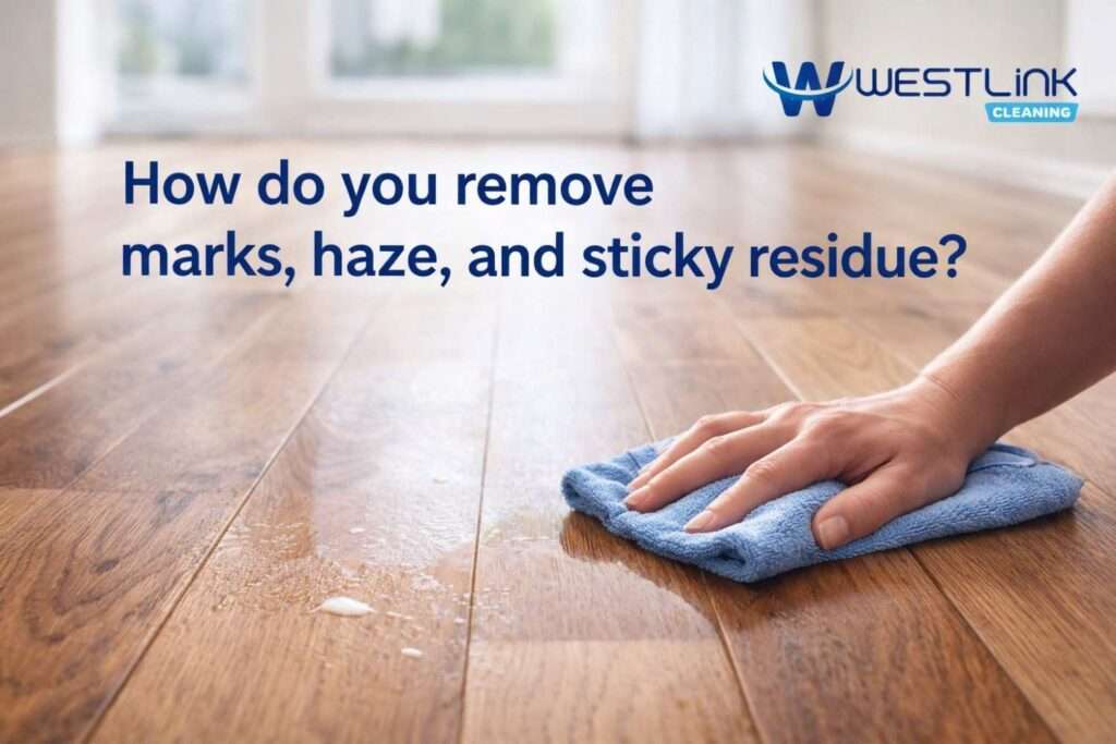 Microfiber cloth removing marks haze and sticky residue from a polished timber floor