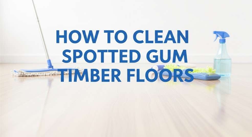 Shiny spotted gum timber floor with cleaning tools arranged neatly.