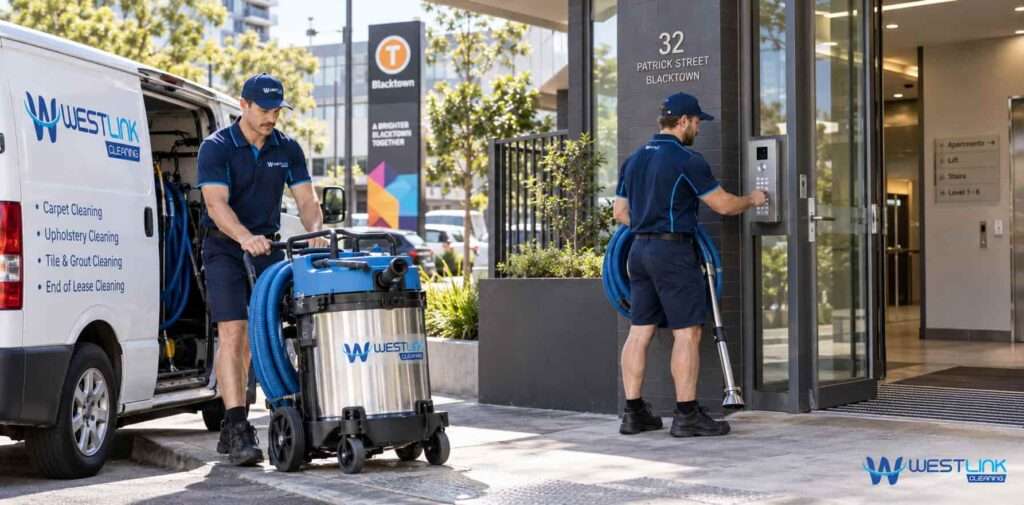 Westlink Cleaning team unloading carpet cleaning equipment and using building access controls at a Blacktown apartment entrance.