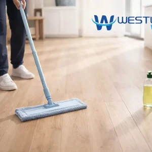 Person cleaning laminate floor with a barely damp microfiber mop and a small bottle of dish soap in a modern home