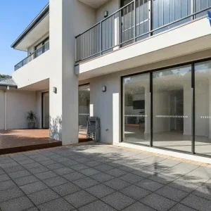 Modern Australian exterior with painted walls, timber, metal, concrete, and glass exposed to outdoor weather.