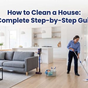 Professional cleaner mopping the floor of a tidy modern house with a vacuum and cleaning caddy nearby