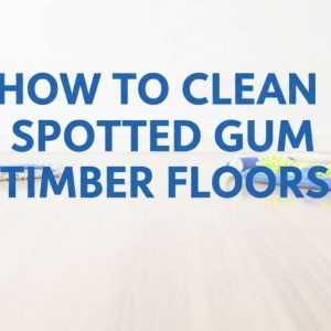 Shiny spotted gum timber floor with cleaning tools arranged neatly.